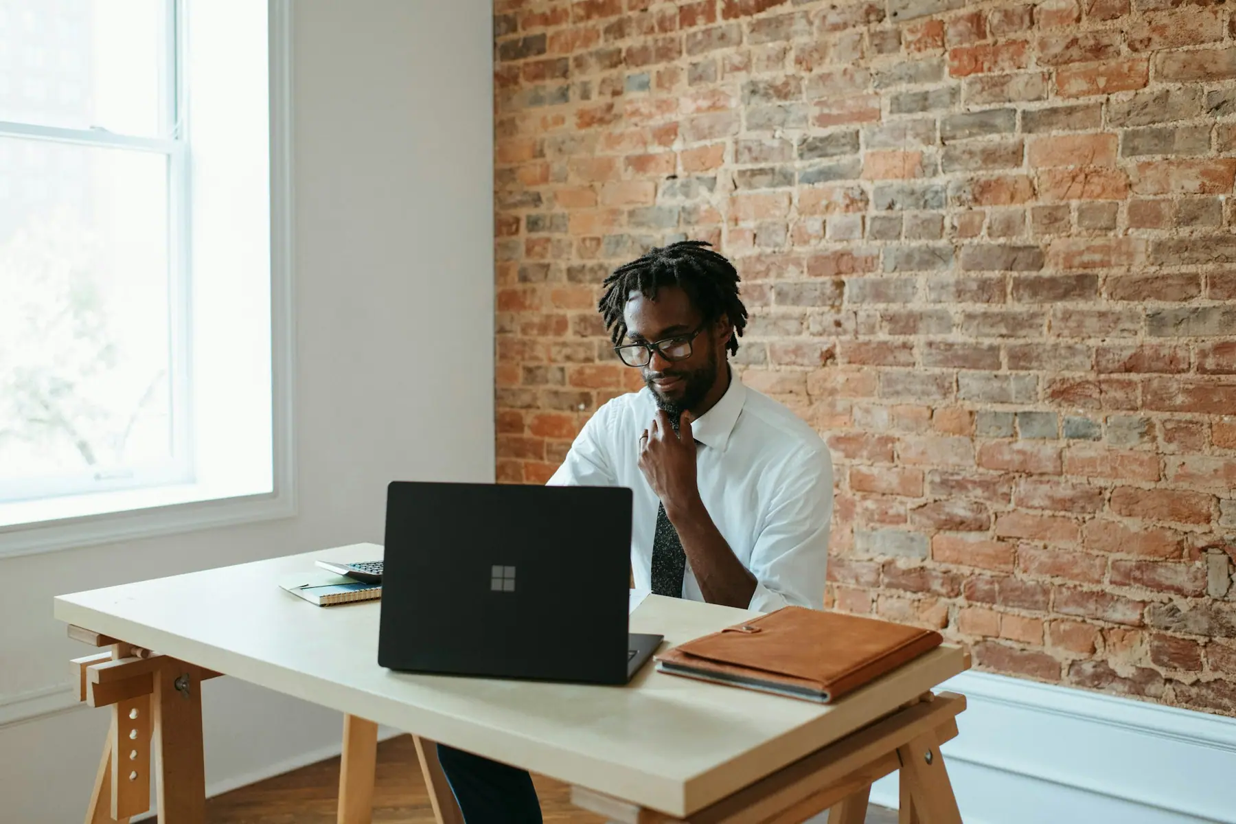Business owner working through a problem at his laptop